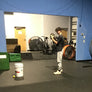 Studio setup with equipment and people in a room with a blue wall.